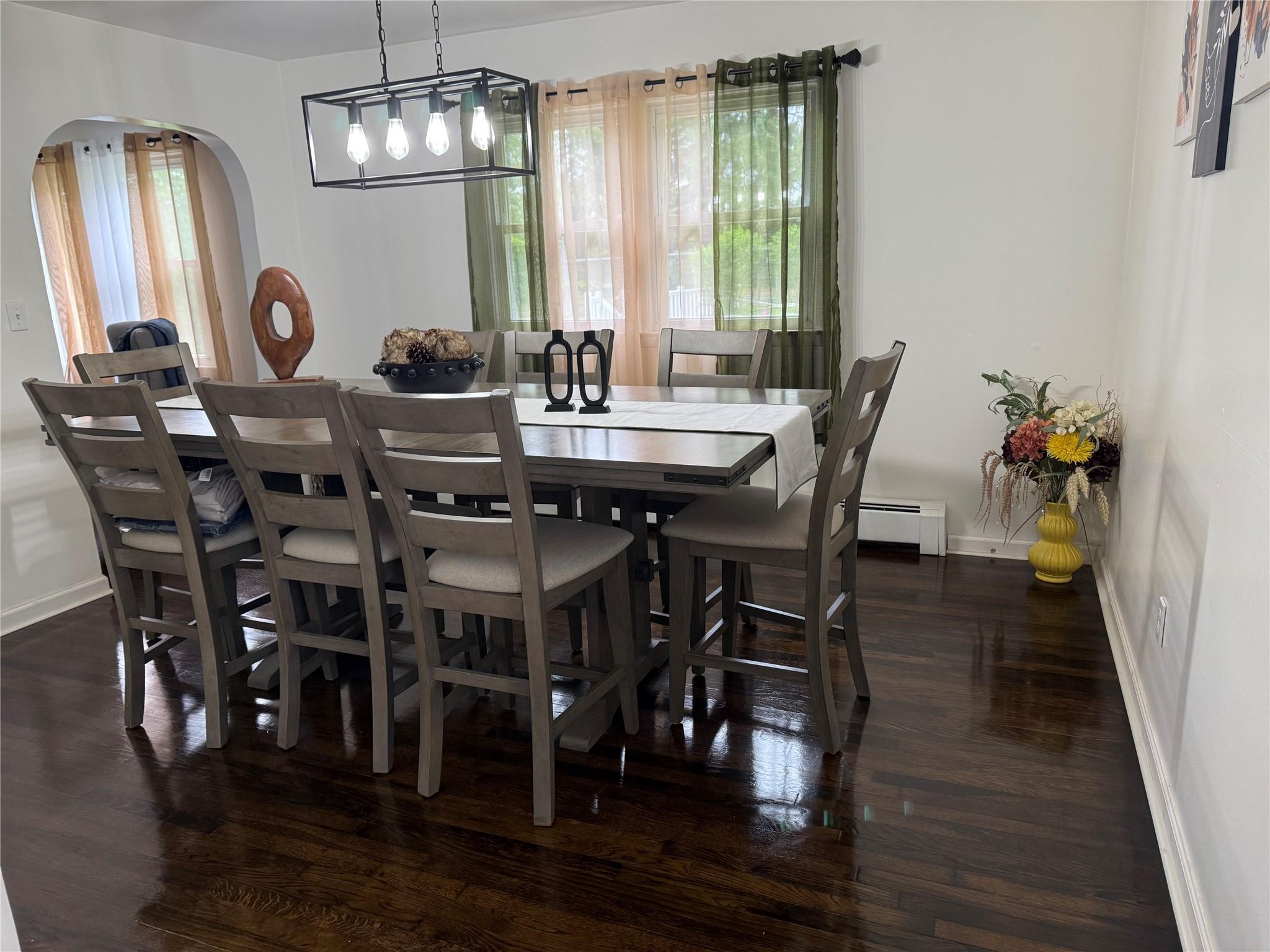 77 Upper Road Middletown, NY 10940 - Photo 4 of 18 Dining space featuring arched walkways, baseboards, dark wood-type flooring, and baseboard heating