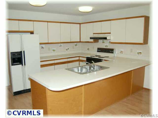 3000 Middlewood Road Midlothian, VA 23113 - Photo 2 of 8 a kitchen with stainless steel appliances granite countertop a sink a stove and a refrigerator