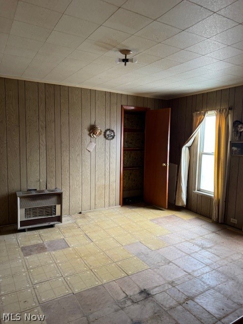 626 High Street Wellsburg, WV 26070 - Photo 15 of 18 Spare room featuring heating unit, wood walls, and light flooring