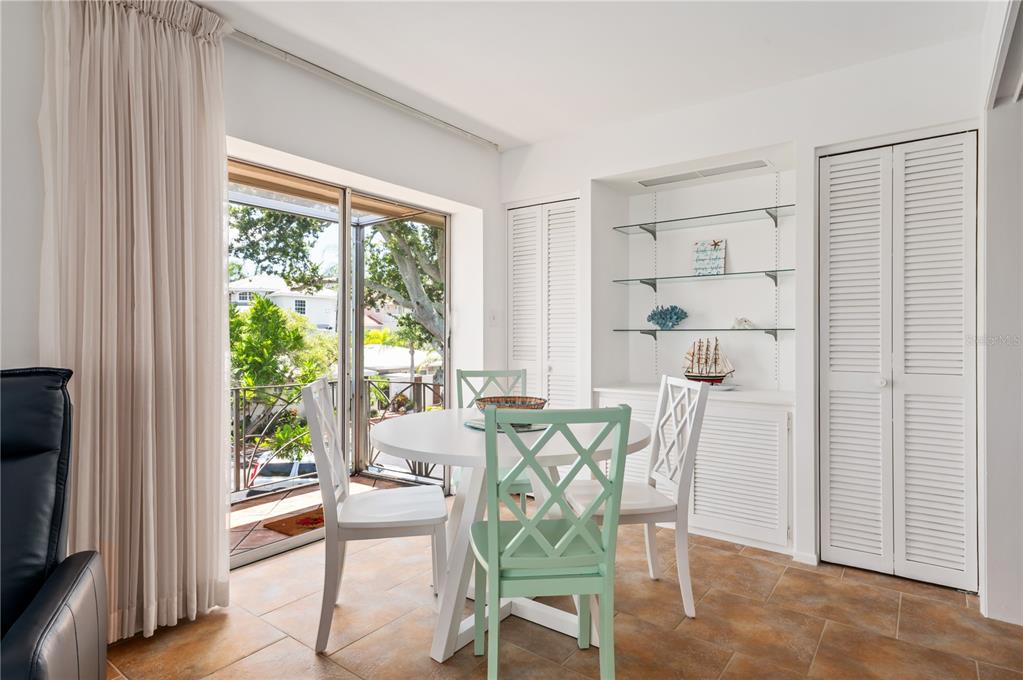 6005 Midnight Pass Road, Unit N13 Sarasota, FL 34242 - Photo 13 of 27 a view of a dining room with furniture window and outside view