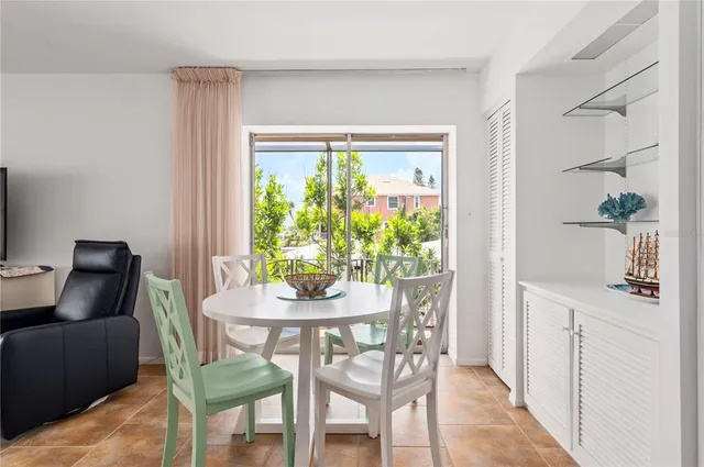 a dining room with furniture and a potted plant