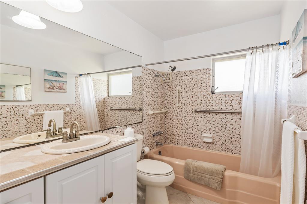 6005 Midnight Pass Road, Unit N13 Sarasota, FL 34242 - Photo 19 of 27 a bathroom with a sink toilet and shower