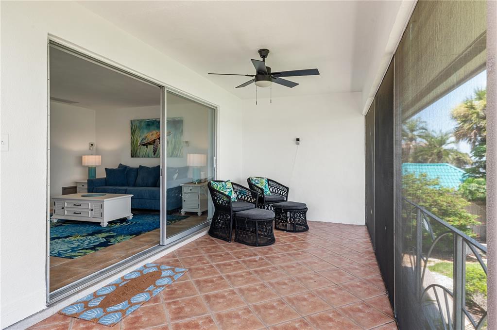 6005 Midnight Pass Road, Unit N13 Sarasota, FL 34242 - Photo 22 of 27 a living room with furniture and a floor to ceiling window