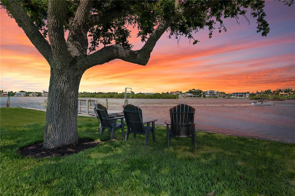 6005 Midnight Pass Road, Unit N13 Sarasota, FL 34242 - Photo 4 of 27 a view of a lake with couches in the patio and a yard