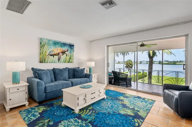 a living room with furniture and a floor to ceiling window