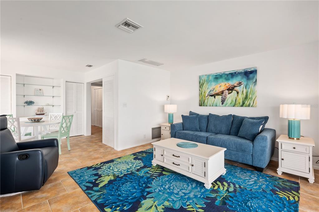 6005 Midnight Pass Road, Unit N13 Sarasota, FL 34242 - Photo 10 of 27 a living room with furniture and a rug