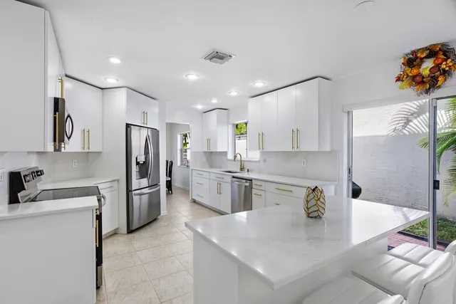 a kitchen with refrigerator and stove