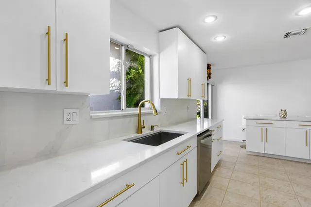 a kitchen with a sink and cabinets