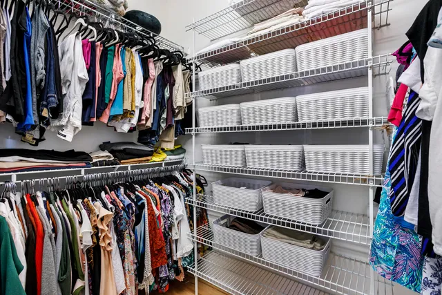 a view of walk in closet with clothes