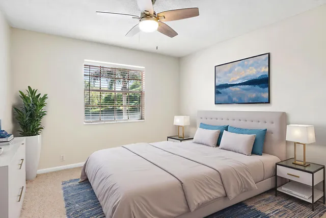 a bedroom with a large bed and a chandelier