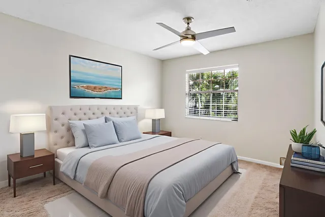 a bedroom with a bed and a painting on the wall