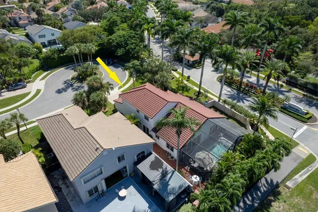 an aerial view of a house with swimming pool and outdoor seating