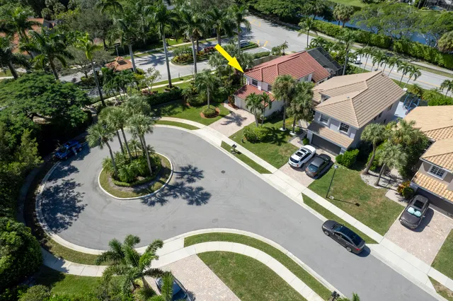 an aerial view of a house with a yard and lake view