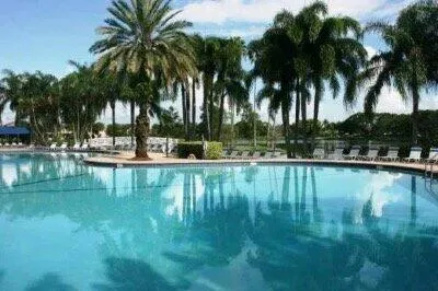 an aerial view of a house with a yard and lake view