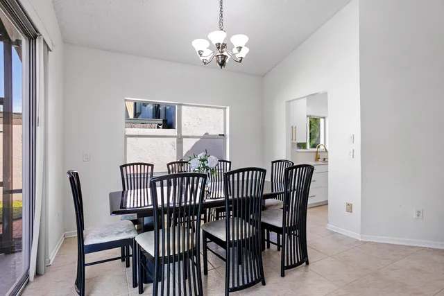 a view of a dining room with furniture and a chandelier