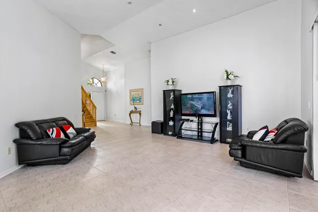 a living room with furniture a flat screen tv and a couch