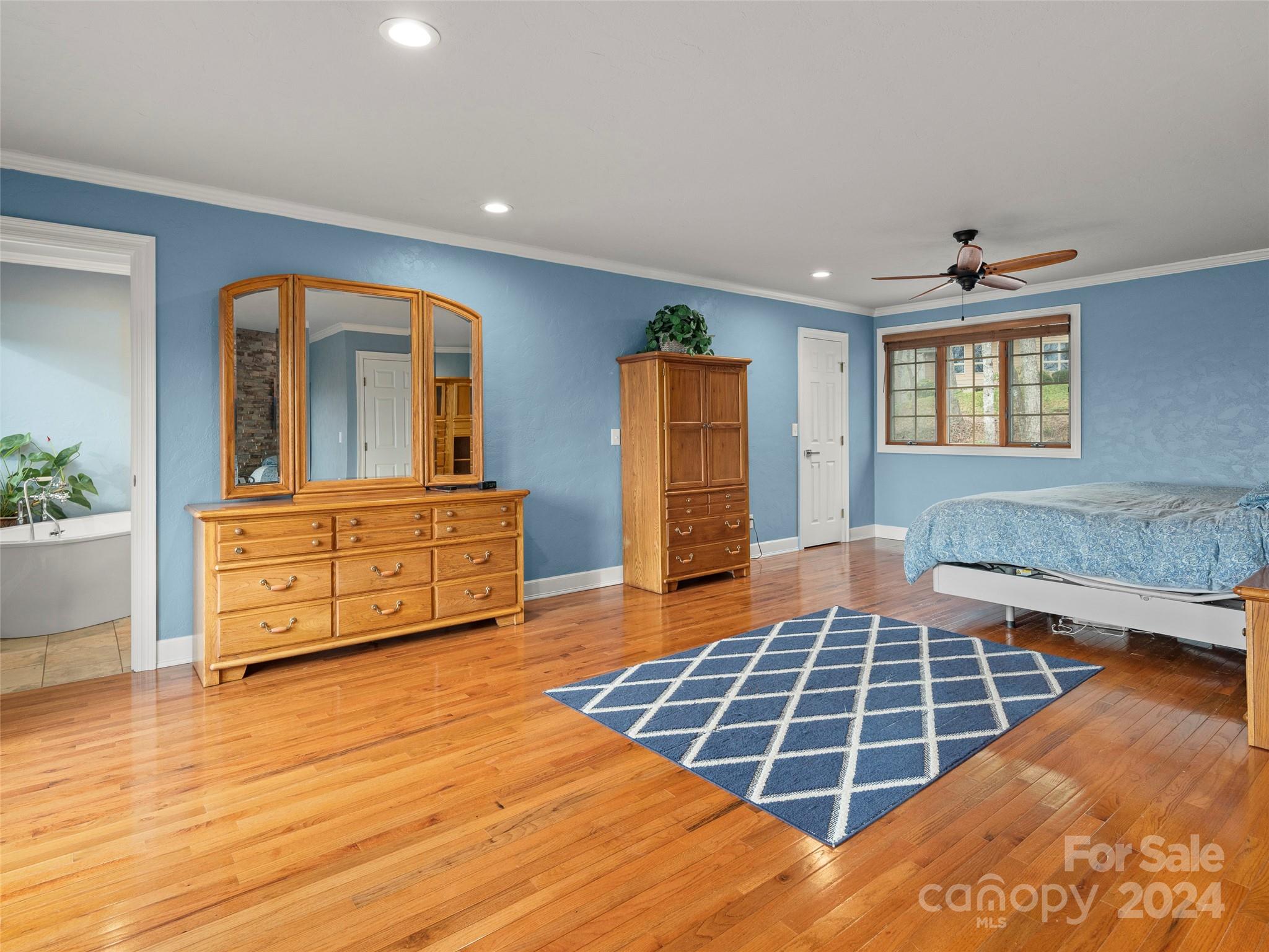5571 Spring Road Hendersonville, NC 28739 - Photo 20 of 41 a living room with a dresser and a wooden floor