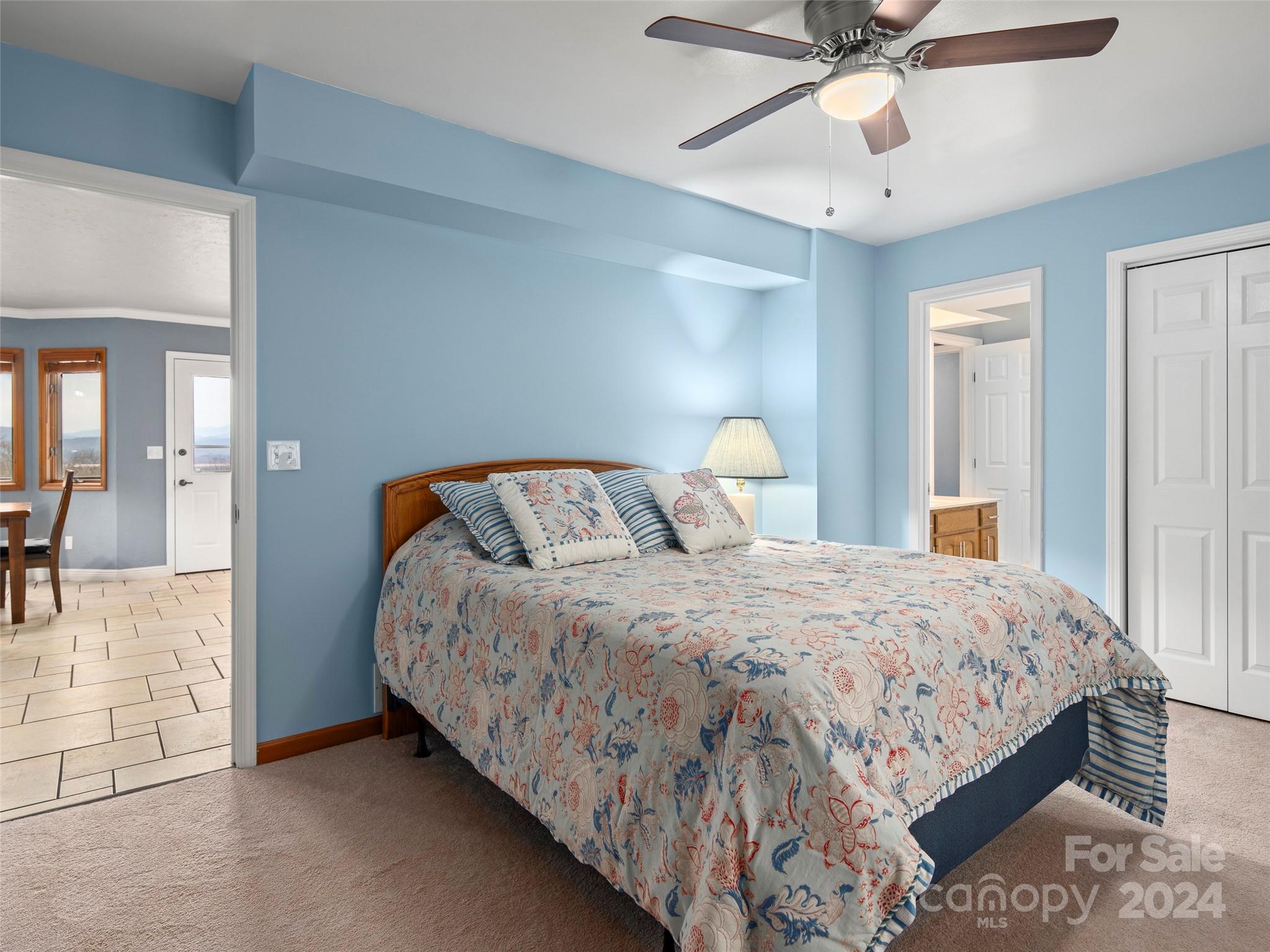 5571 Spring Road Hendersonville, NC 28739 - Photo 27 of 41 a bedroom with a bed and ceiling fan