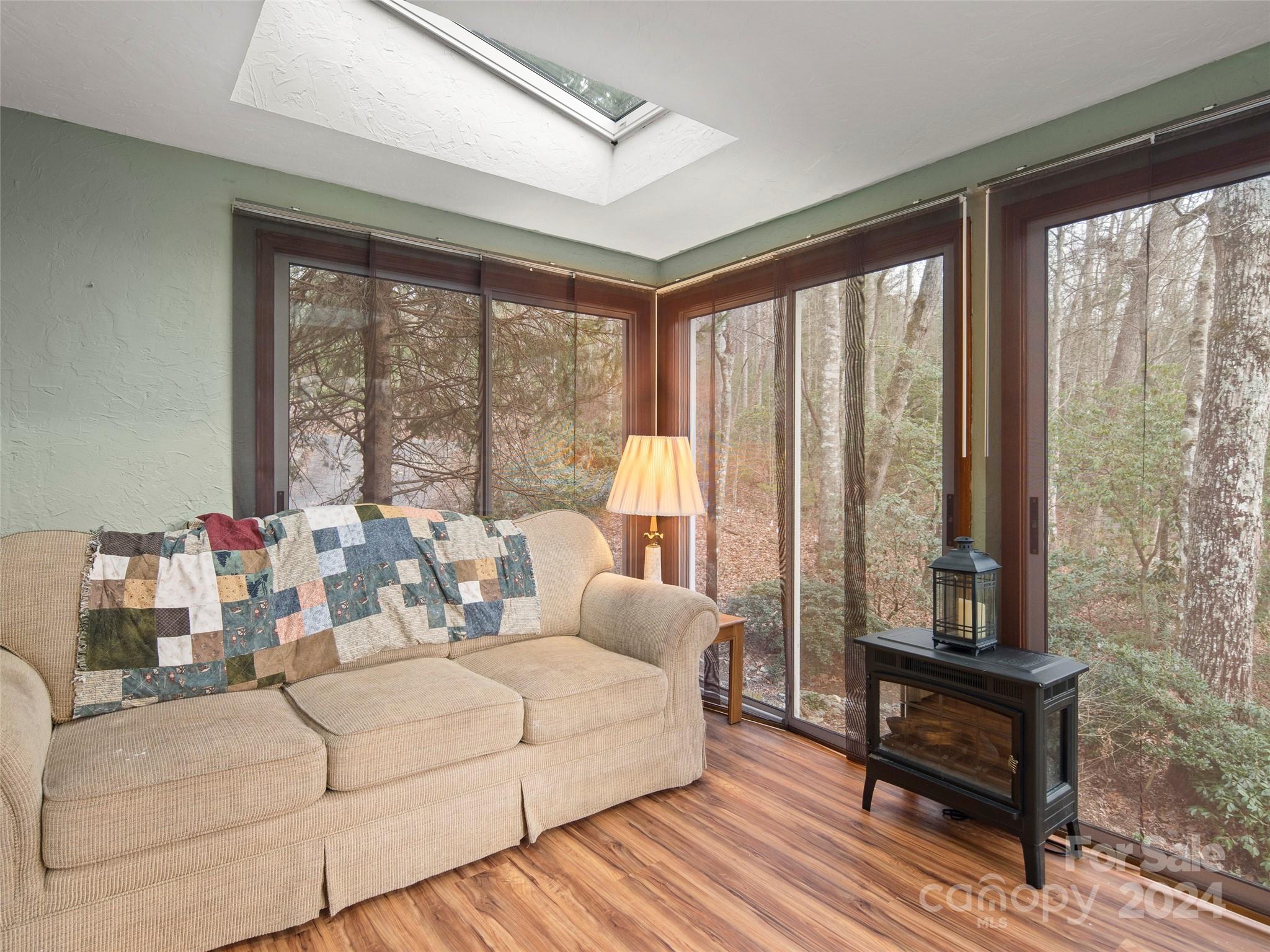5571 Spring Road Hendersonville, NC 28739 - Photo 31 of 41 a living room with furniture and a floor to ceiling window