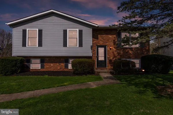 a front view of house with a garden
