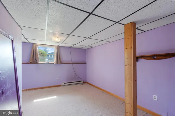 a view of empty room with wooden walls