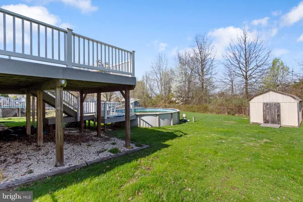 a view of a house with a big yard and potted plants