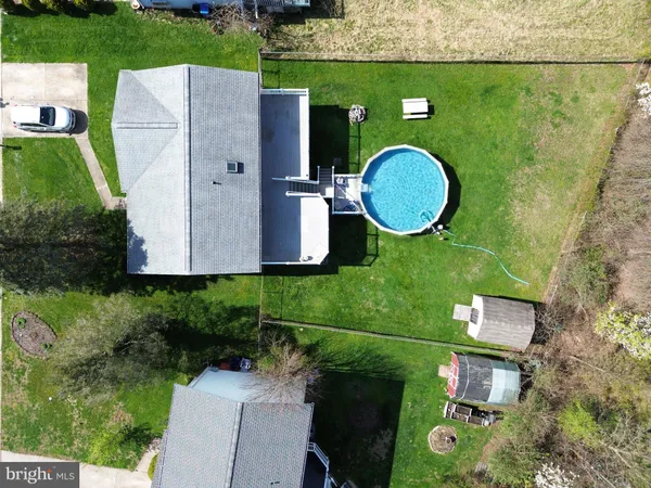 a view of a house with a backyard and a garden