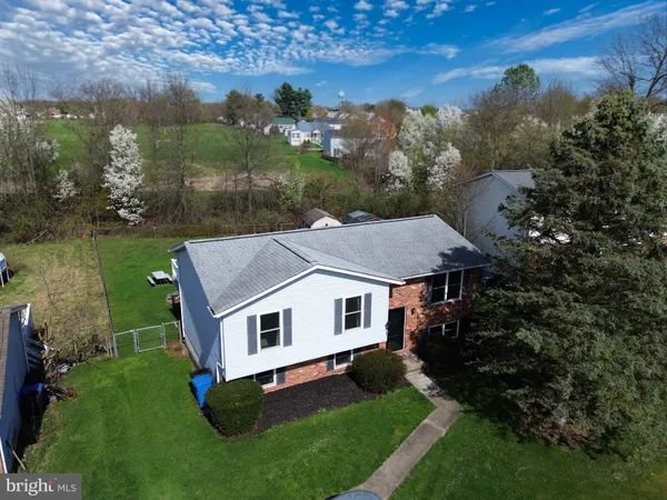 a aerial view of a house with a yard table and chairs
