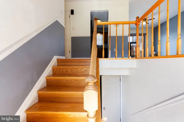 a view of staircase with lots of frames on wall