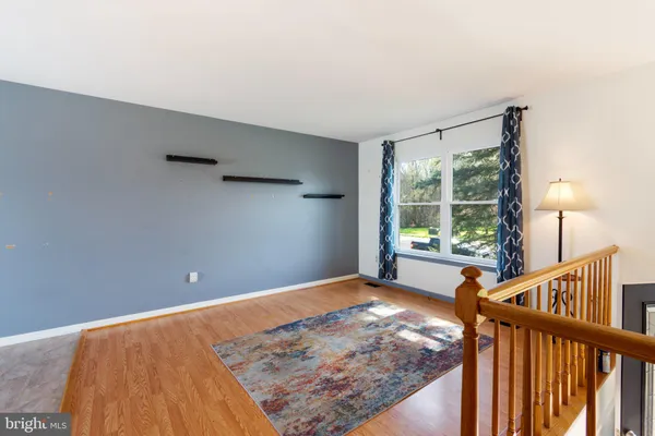 a view of a room with wooden floor and a window