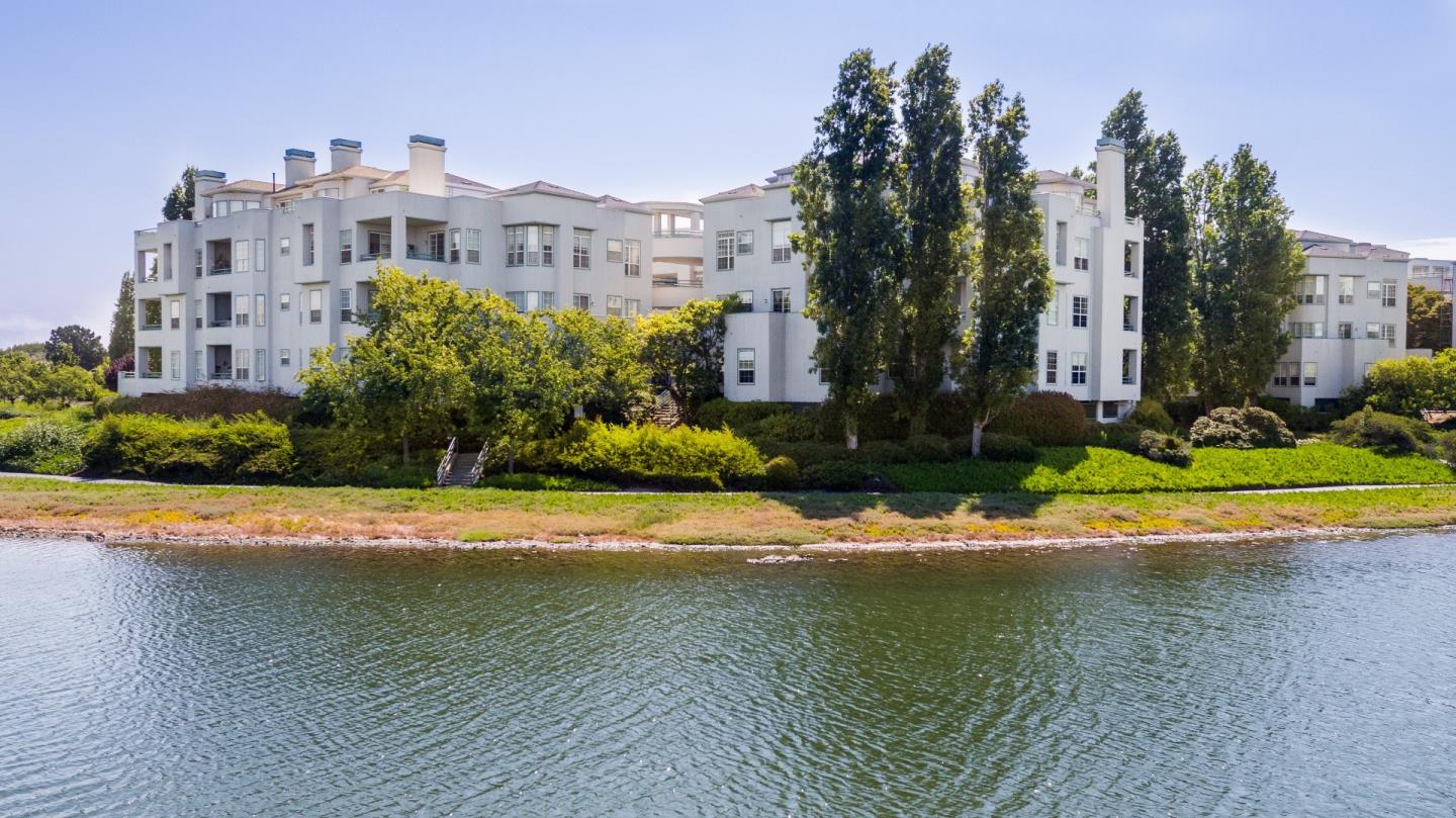 720 Promontory Point Lane, Unit 2106 Foster City, CA 94404 - Photo 1 of 35 a view of a house with a yard and a large pool
