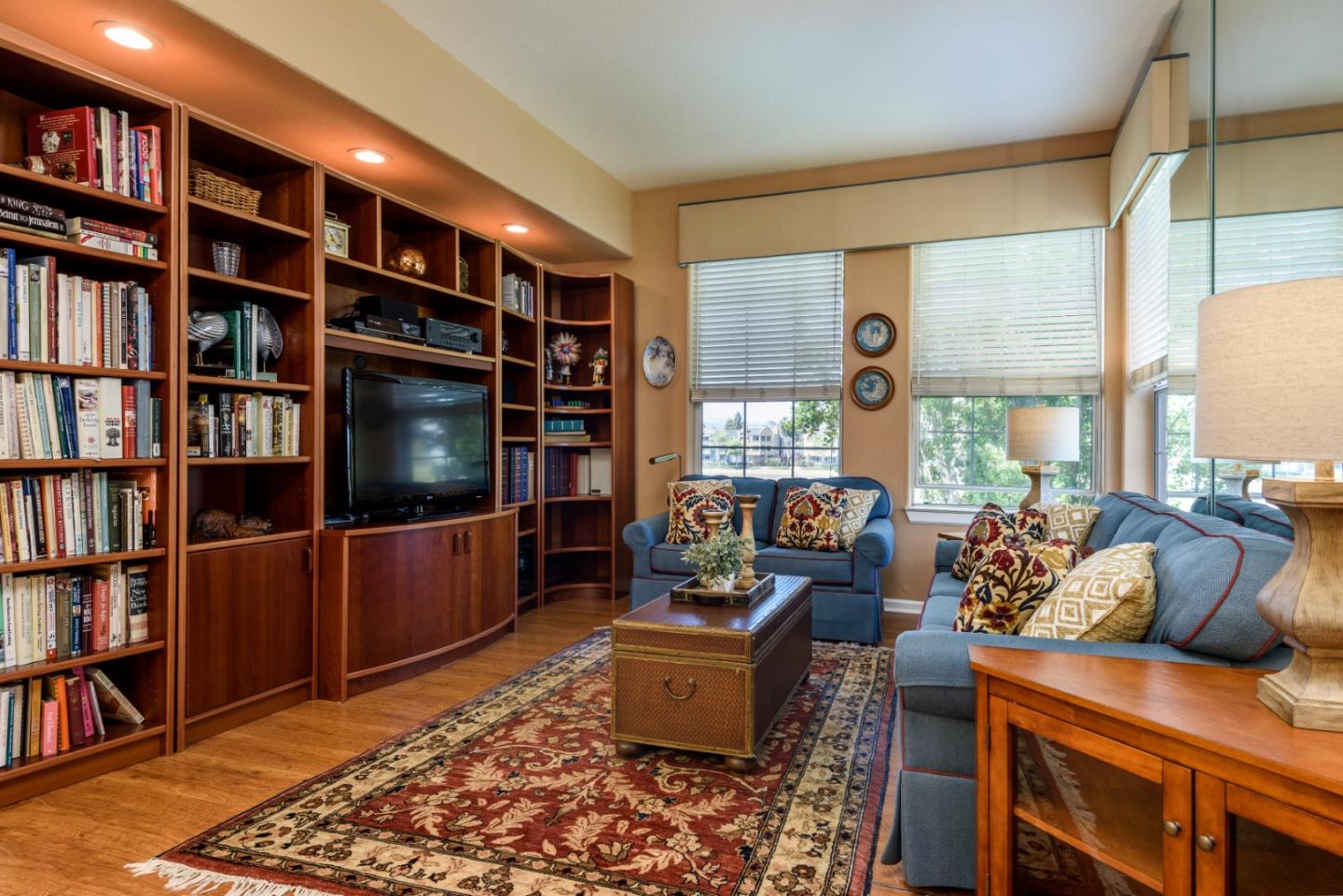 720 Promontory Point Lane, Unit 2106 Foster City, CA 94404 - Photo 13 of 35 a living room with furniture and a book shelf
