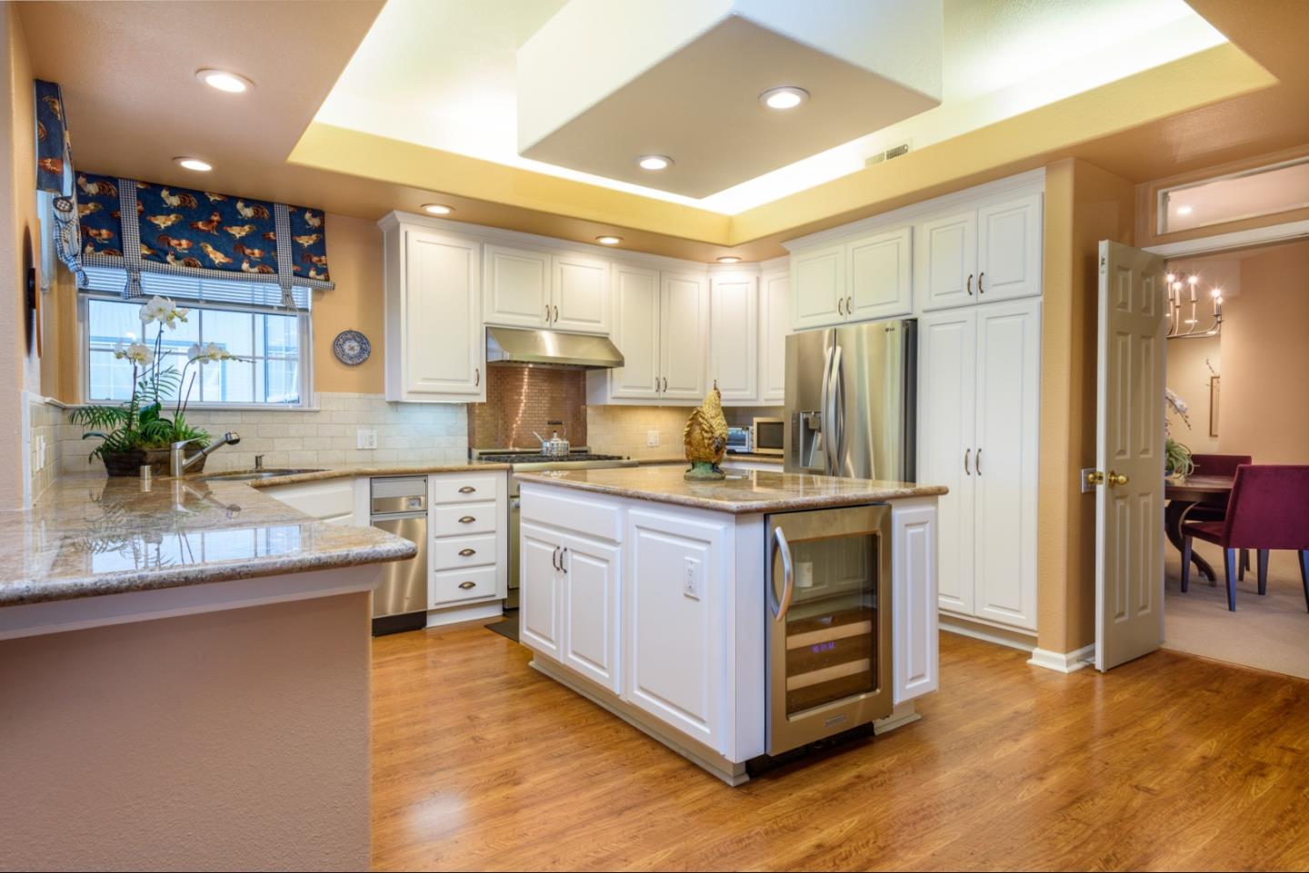 720 Promontory Point Lane, Unit 2106 Foster City, CA 94404 - Photo 10 of 35 a kitchen with stainless steel appliances granite countertop a sink a stove a refrigerator and island
