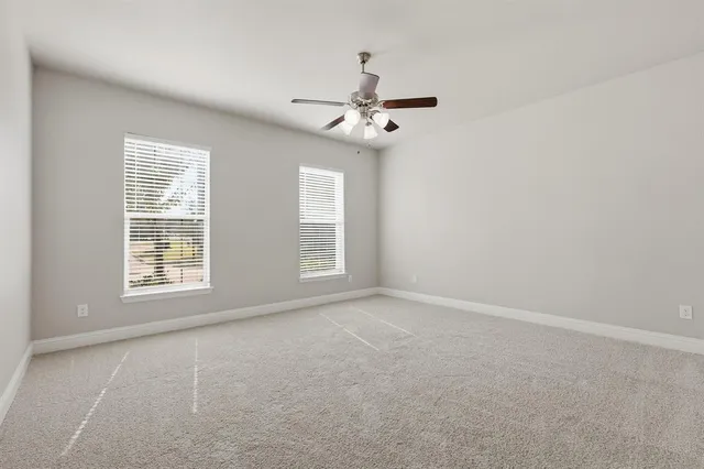 a bathroom with a granite countertop sink a toilet mirror and bathtub