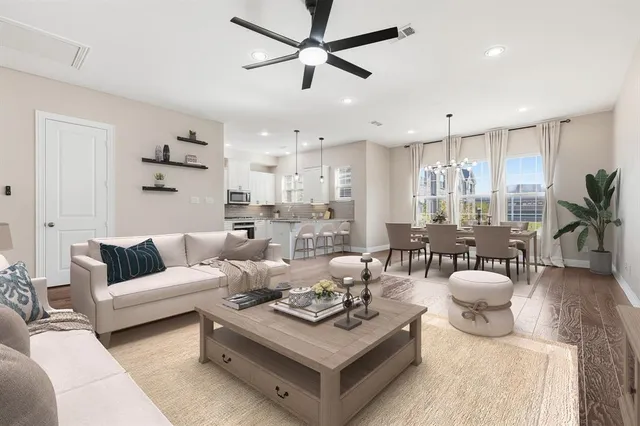 a kitchen with stainless steel appliances granite countertop white cabinets a sink a stove and a microwave