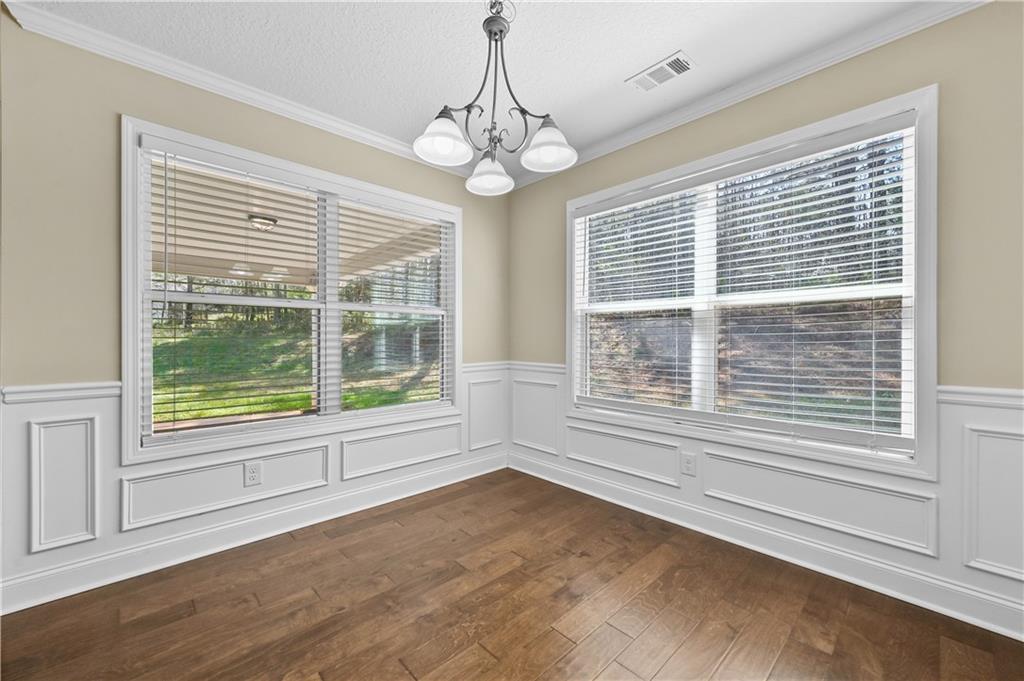 9 Bailee Circle Colbert, GA 30628 - Photo 13 of 30 a view of an empty room with wooden floor and a window