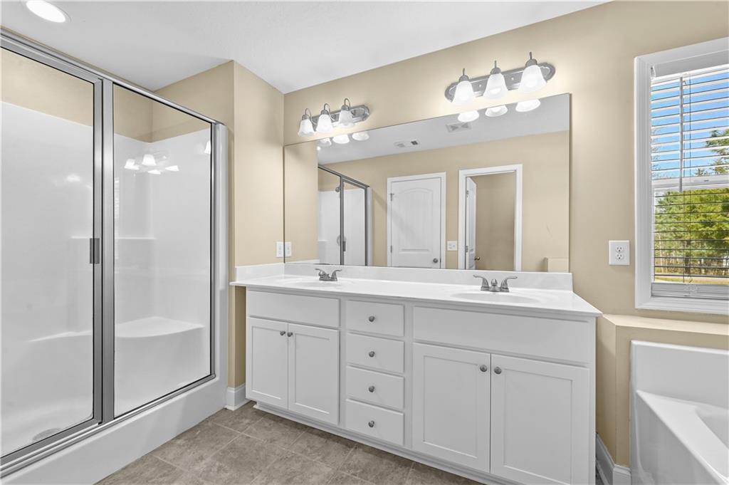 9 Bailee Circle Colbert, GA 30628 - Photo 19 of 30 a bathroom with double vanity sinks and a mirror