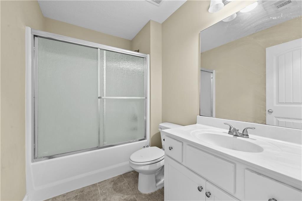 9 Bailee Circle Colbert, GA 30628 - Photo 22 of 30 a bathroom with a sink toilet vanity and shower