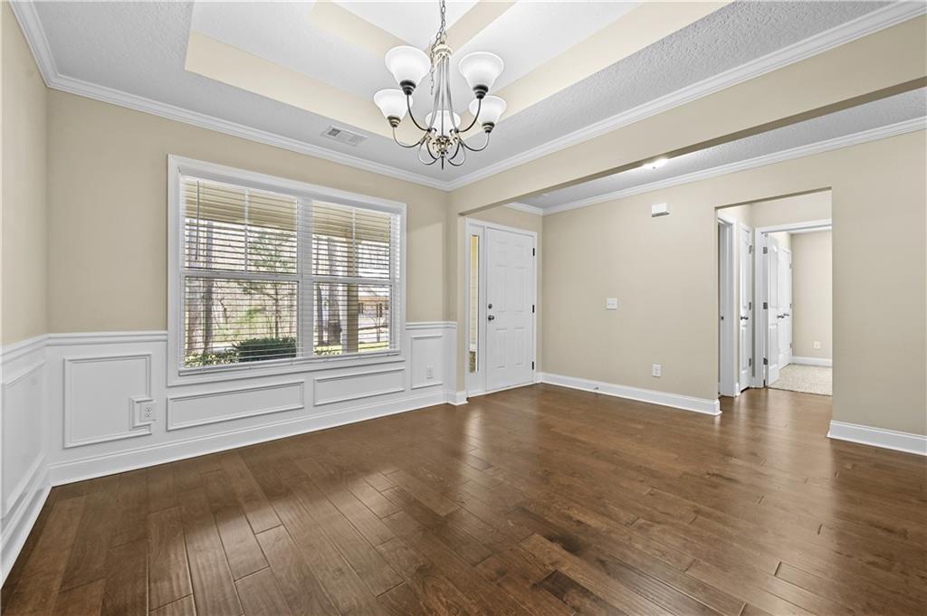 9 Bailee Circle Colbert, GA 30628 - Photo 4 of 30 a view of an empty room with wooden floor and a window