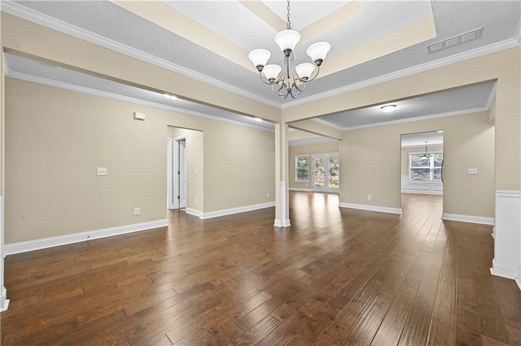 9 Bailee Circle Colbert, GA 30628 - Photo 5 of 30 a view of an empty room with wooden floor and a ceiling fan
