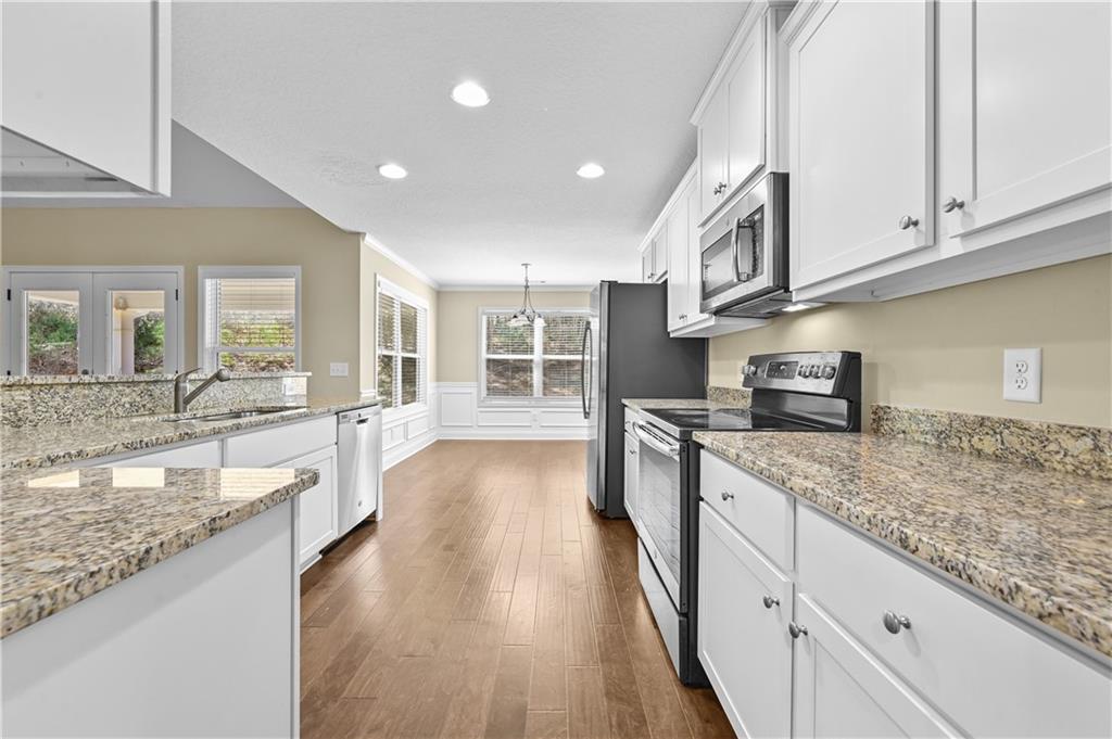 9 Bailee Circle Colbert, GA 30628 - Photo 10 of 30 a large kitchen with granite countertop a large counter top appliances and cabinets