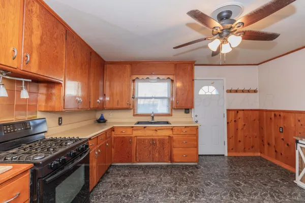 a kitchen with stainless steel appliances granite countertop a sink stove and cabinets