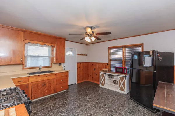 a kitchen with cabinets a sink and stainless steel appliances