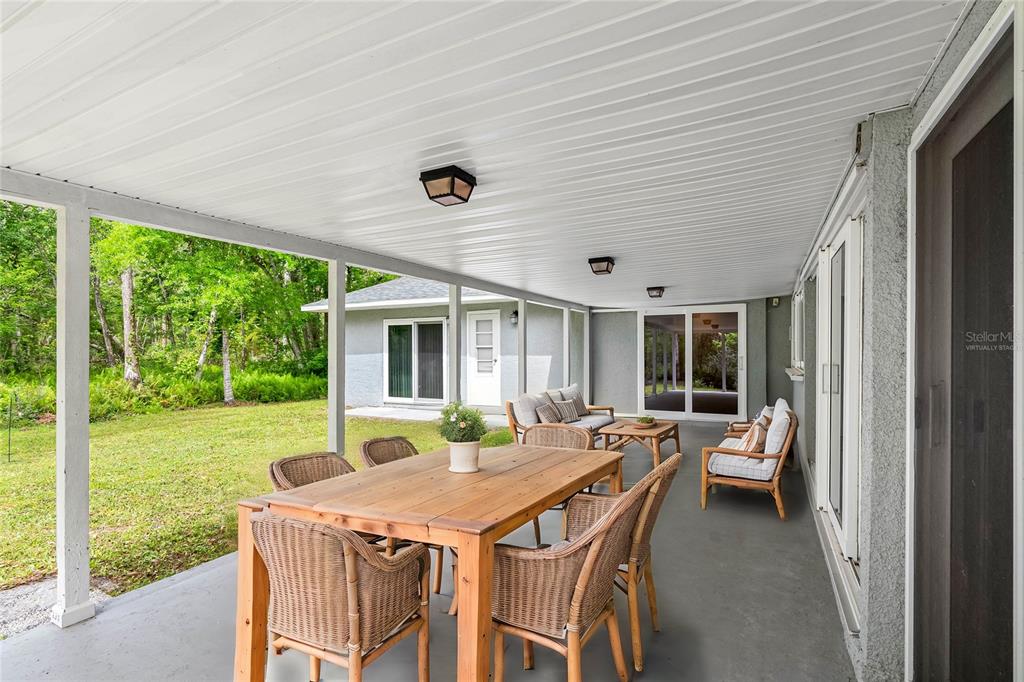 346 Ranch Road Tarpon Springs, FL 34688 - Photo 16 of 64 a dinning table and chairs in the porch