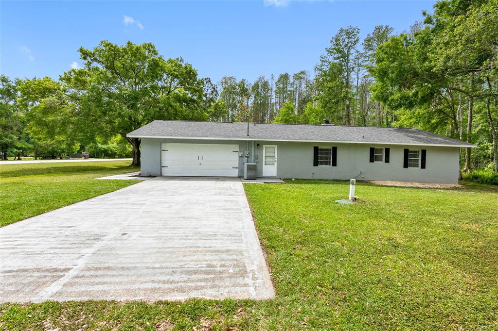 346 Ranch Road Tarpon Springs, FL 34688 - Photo 19 of 64 a front view of a house with a yard