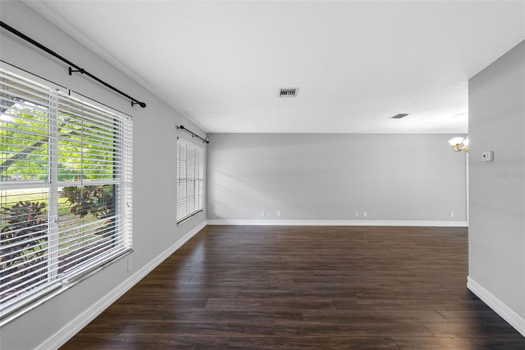 346 Ranch Road Tarpon Springs, FL 34688 - Photo 22 of 64 a view of an empty room with wooden floor and a window