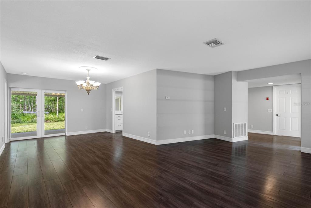 346 Ranch Road Tarpon Springs, FL 34688 - Photo 23 of 64 a view of an empty room with wooden floor and a window