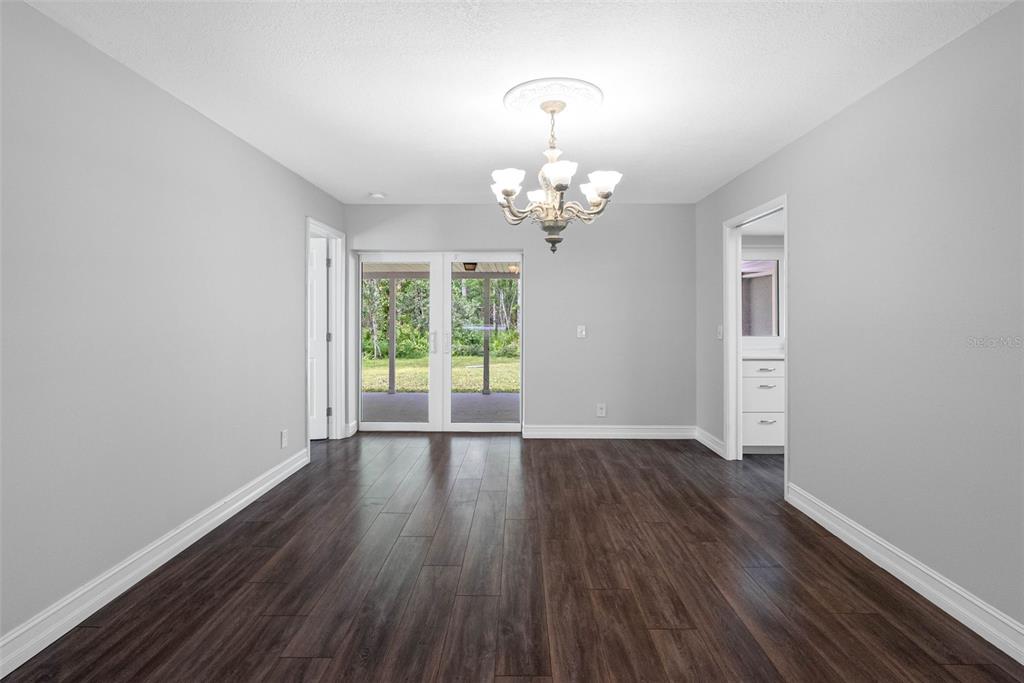 346 Ranch Road Tarpon Springs, FL 34688 - Photo 25 of 64 wooden floor in an empty room with a window