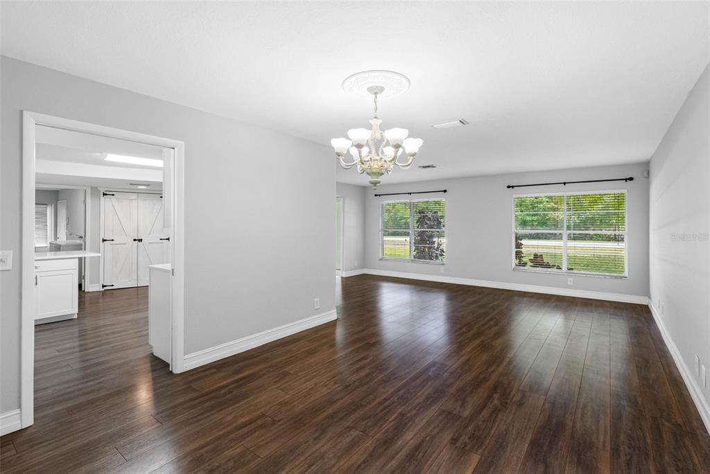 346 Ranch Road Tarpon Springs, FL 34688 - Photo 26 of 64 an empty room with wooden floor and windows