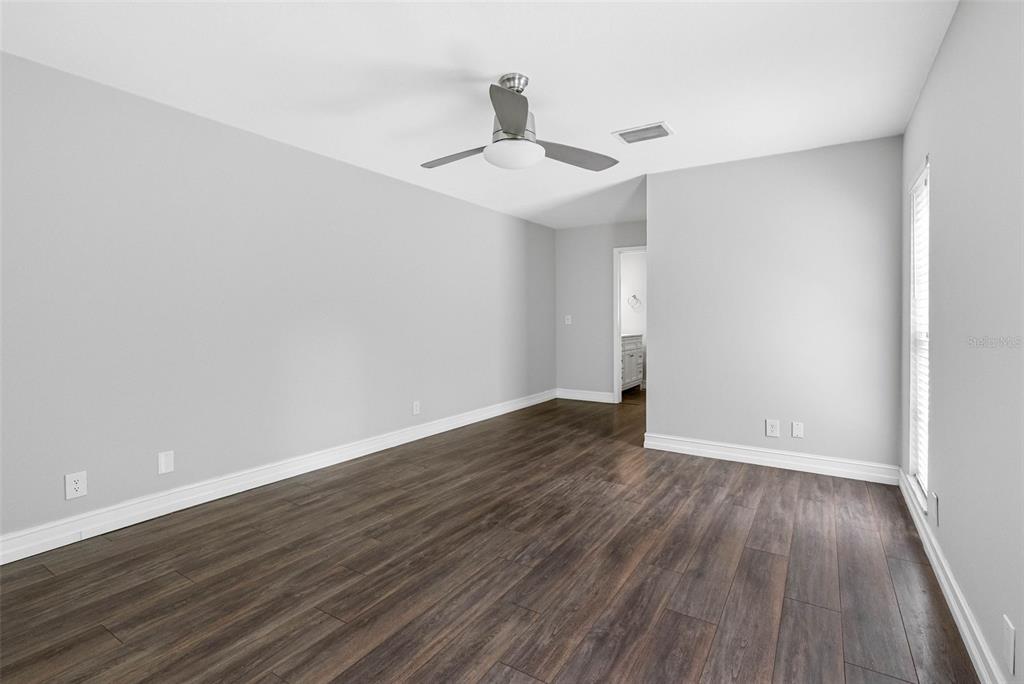 346 Ranch Road Tarpon Springs, FL 34688 - Photo 28 of 64 a view of an empty room with wooden floor